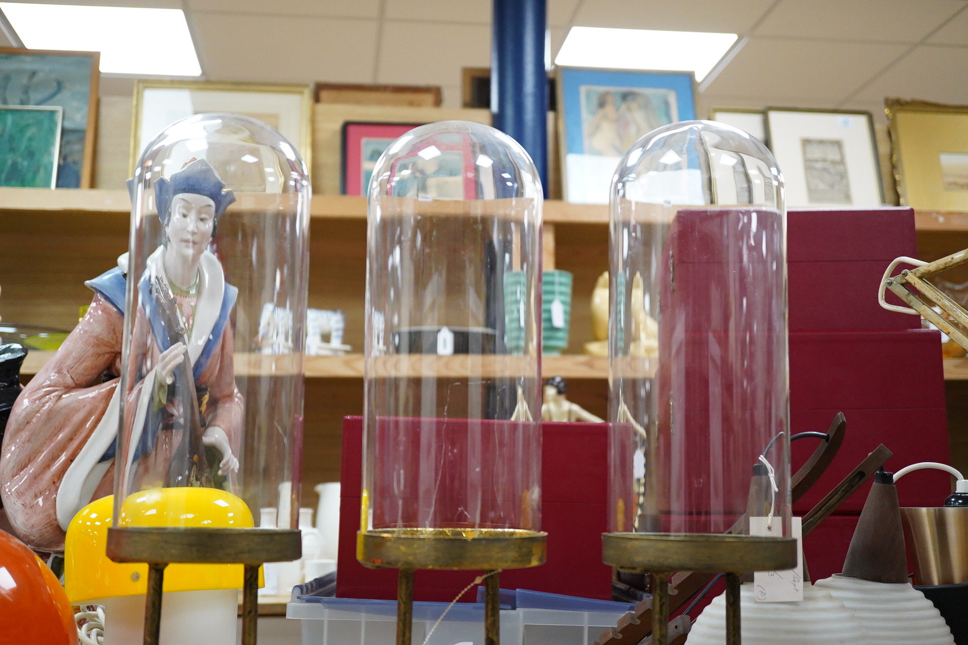 A trio of unusual glass domed display cases on ‘birds feet’ stands, 45cm